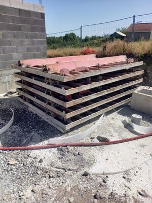 a pile of wood sitting on top of a pile of concrete