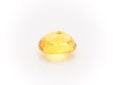 a yellow sapphire stone on a white background