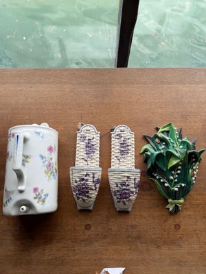 a wooden table topped with vases and a plant