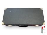 an open black briefcase sitting on top of a white surface