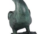 bronze statue of a pelican on a base on a white background