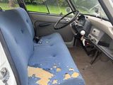 a dirty seat in the back of a van
