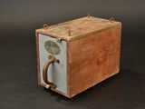 a small wooden box with a handle on it