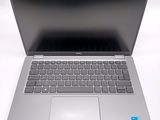an open laptop computer sitting on top of a white table