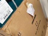 a box that is sitting on the floor next to a refrigerator