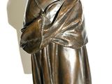 a statue of a woman holding a cell phone