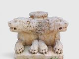 a statue of a group of animals that are sitting on the ground