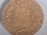 a close up of a gold coin with a coat of arms on it