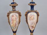 une paire de vases bleus et dorés posés sur un sol à carreaux