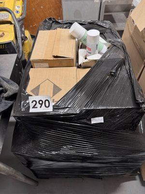 a pile of boxes sitting on a cart in a warehouse