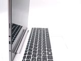 a laptop computer sitting on top of a white table