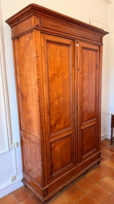 a large wooden cabinet in the corner of a room