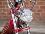 a close up of a red motorcycle with a light on it