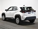 the rear end of a white toyota rav parked on a checkered floor