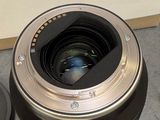 a camera lens sitting on the ground next to a box