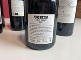 several bottles of wine are lined up on a table