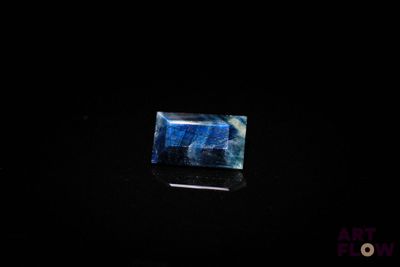 a picture of a blue and white stone in the dark