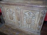 a wooden chest with carvings on it on a table