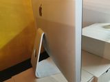 an apple computer sitting on top of a cardboard box on a table