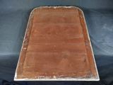 an old wooden tray sitting on top of a blue cloth