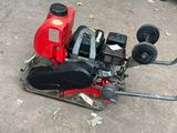 a small red machine that is sitting on the ground
