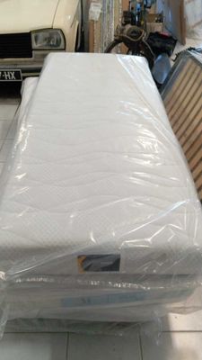 a mattress that is wrapped in plastic and sitting on the floor