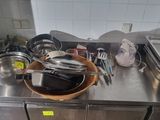 many pots and pans on the counter in the kitchen