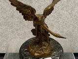 statue en bronze d'une femme tenant un oiseau sur un socle en marbre