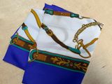 a blue and white scarf with a gold chain on it