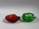 two glass bowls sitting next to each other on a table
