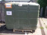 a large green container sitting on a pallet in a parking lot