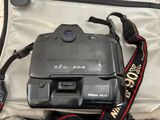 a camera sitting on top of a piece of luggage