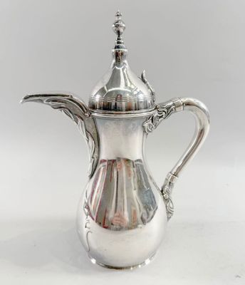 an image of a silver coffee pot sitting on top of a white table