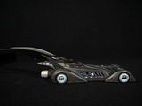 a toy car that is sitting on a black surface
