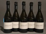 six bottles of wine are lined up on a table