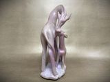 a figurine of a woman and a dog on a table
