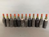 six bottles of wine lined up in a row on a table