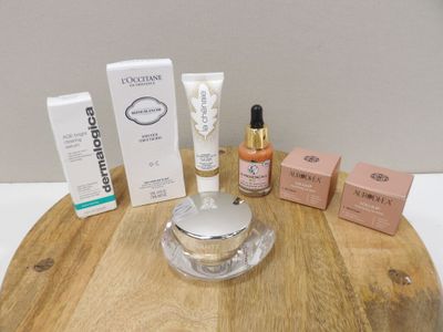 a wooden table with a lot of cosmetics and a bottle of lotion