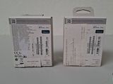 two boxes of electronic equipment sitting on top of a white table
