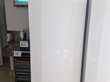 three refrigerators that are sitting in a room