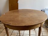 a round table with a wooden top in a kitchen