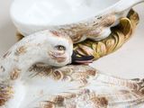 a bird that is sitting on top of a bowl