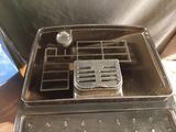 a metal tray with a metal lid on top of a stove