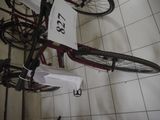 a bicycle that is hanging on the wall next to a sign
