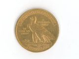 a gold coin with a bird on it on a white surface