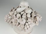 a white vase with a bunch of flowers inside of it