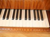 a close up of a piano keyboard on a wooden floor