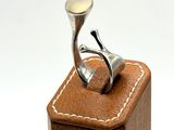 a wooden box with a ring on top of it