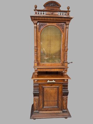 an old wooden cabinet with a glass door on top of it