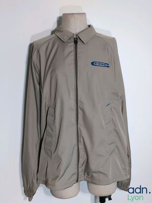 a grey jacket on a mannequin stand with a white background
